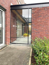 Stalen scheidingswand binnenplaats-Stalendeurenhuys-tuin-Stalen industriële deur als scheidingswand-OBLY