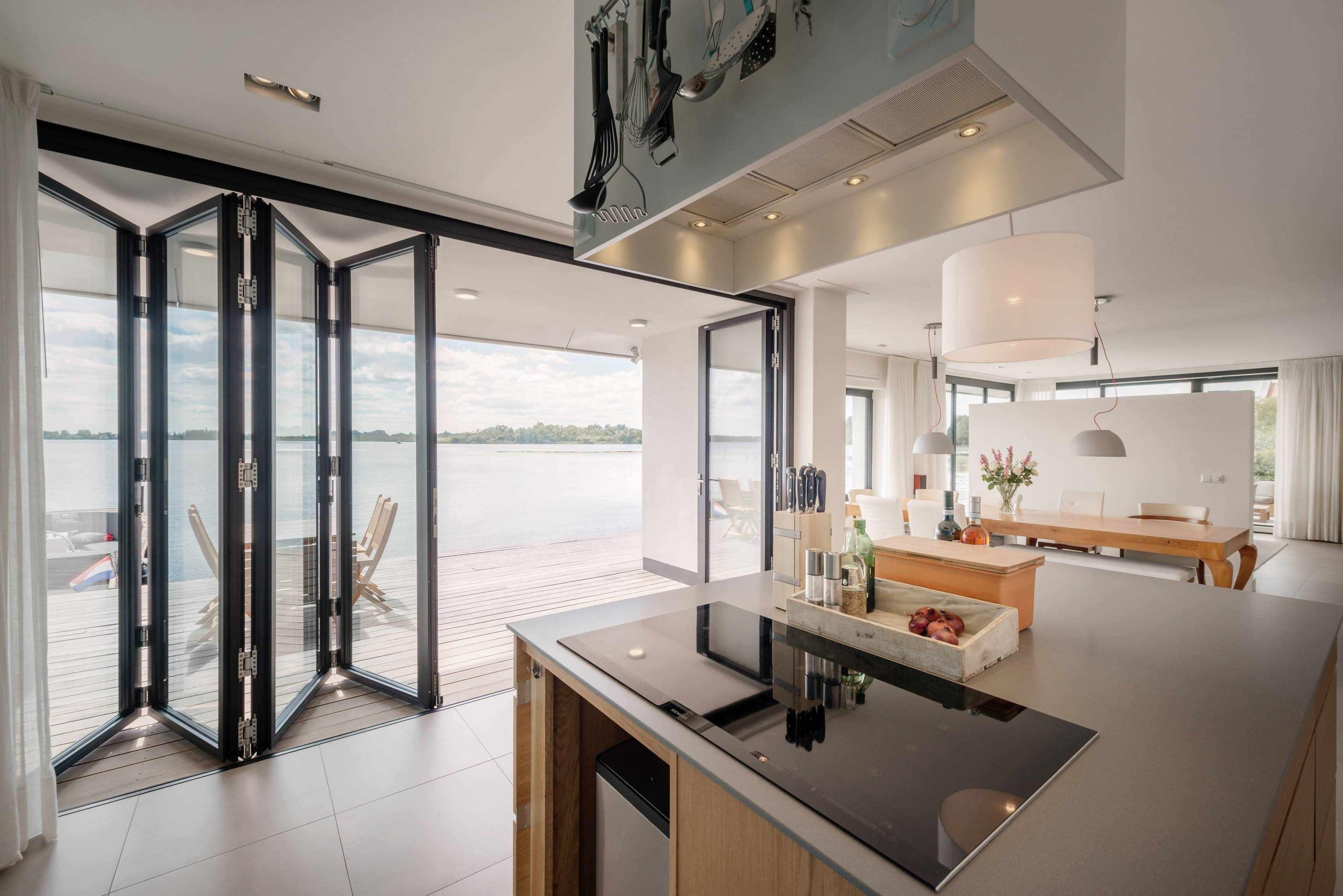 Vouwwanden tuinkamer-Goes serres-glazen serre,keuken,moderne serre,serre,serre aan het water,serre aanbouw,serre woning-Vouwwanden tuinkamer Goes serres-OBLY