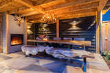 Bar in moderne Oostenrijkse sfeer met doorkijk openhaard-OBLY-Bar-Ontdek deze stijlvolle bar met warme houttinten en strakke lijnen. Een-OBLY
