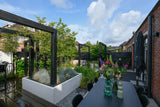 Een moderne tuin als verlengstuk van de woning-Leonardus buiten-architectonische tuin,luxe stadstuin,maatwerk plantenbakken,moderne nieuwbouwtuin,moderne pergola,moderne tuin inspiratie,rijke beplanting tuin,siergrassen tuin,tuin,tuin met meerdere zitplekken,zwarte pergola tuin-Moderne nieuwbouwtuin met pergola en beplanting-OBLY