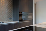 Luxe villa met maatwerk interieur-Oudendorp-badkamermeubel,Donkere keuken,Interieur inspiratie,Keuken op maat,Kookeiland,luxe badkamer,luxe villa,Maatwerk interieur,moderne keuken,moderne villa,Natuursteen,visgraatvloer,vrijstaand ligbad,wellness badkamer,wijnklimaatkast-OBLY