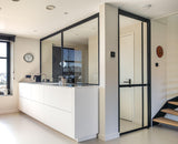 Minimalistische maatwerk keuken met stalen taatsdeur en zwevende trap-OBLY-design keuken,eiken trap,Greeploze keuken,iemms,Interieur inspiratie,Keuken,koffiecorner,Kookeiland,Maatwerk interieur,maatwerk keuken,moderne keuken,stalen taatsdeur,zwevende trap-Complete woningrenovatie met maatwerk keuken | Oudendorp-OBLY