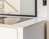 Minimalistische maatwerk keuken met stalen taatsdeur en zwevende trap-OBLY-design keuken,eiken trap,Greeploze keuken,iemms,Interieur inspiratie,Keuken,koffiecorner,Kookeiland,Maatwerk interieur,maatwerk keuken,moderne keuken,stalen taatsdeur,zwevende trap-Complete woningrenovatie met maatwerk keuken | Oudendorp-OBLY
