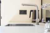 Minimalistische maatwerk keuken met stalen taatsdeur en zwevende trap-OBLY-design keuken,eiken trap,Greeploze keuken,iemms,Interieur inspiratie,Keuken,koffiecorner,Kookeiland,Maatwerk interieur,maatwerk keuken,moderne keuken,stalen taatsdeur,zwevende trap-Complete woningrenovatie met maatwerk keuken | Oudendorp-OBLY