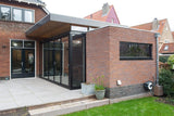 Moderne keukenaanbouw met sterke verbinding met de tuin-Goes serres-glazen schuifpui,keuken aanbouw,moderne uitbouw,open keuken ontwerp,woning uitbreiding-Moderne keuken aanbouw met grote schuifpui-OBLY