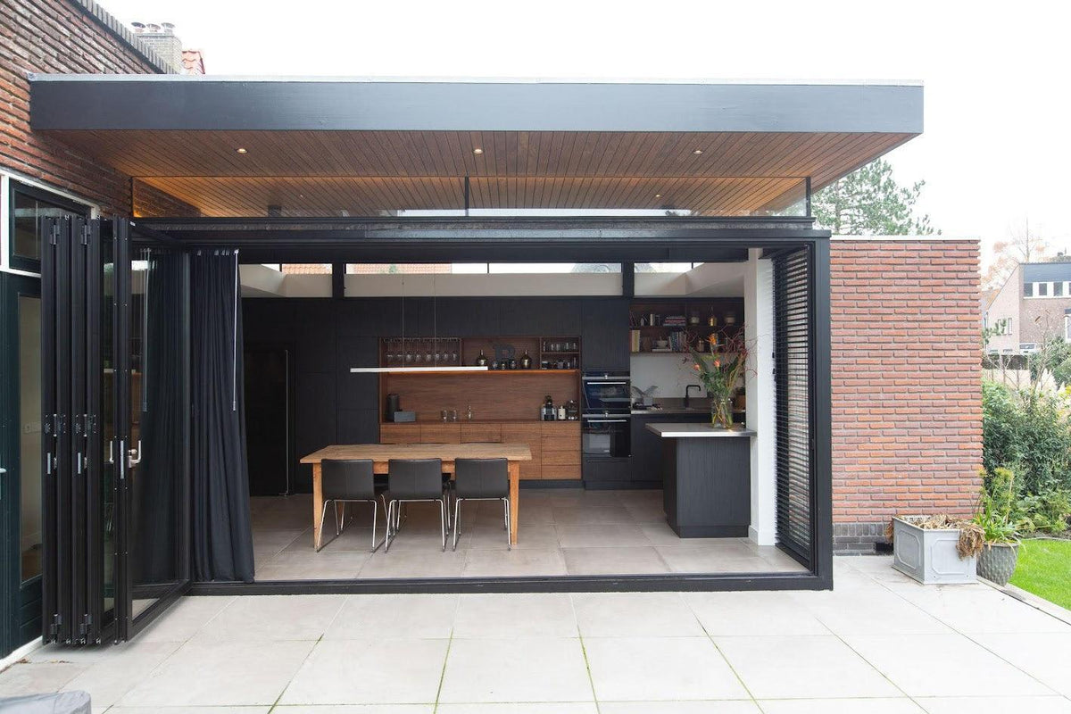 Moderne keukenaanbouw met sterke verbinding met de tuin-Goes serres-glazen schuifpui,keuken aanbouw,moderne uitbouw,open keuken ontwerp,woning uitbreiding-Moderne keuken aanbouw met grote schuifpui-OBLY