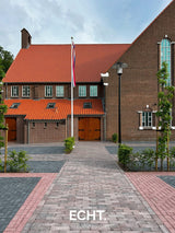 Groen kerkplein bij een monumentaal kerkgebouw